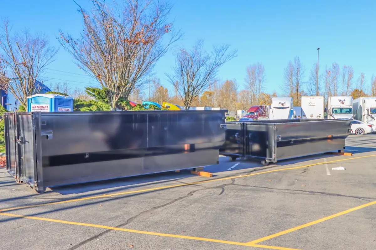 Professional dumpster rental service with roll-off container on residential driveway in Oconomowoc